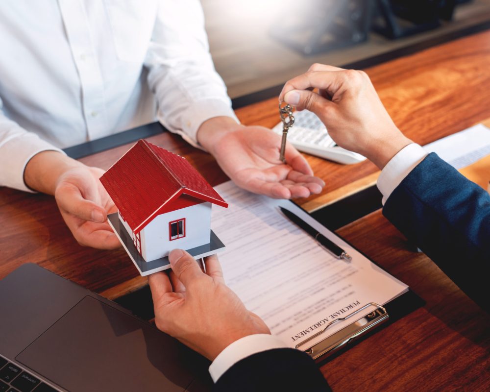 buy or sell real estate concept, Sale representative offer house purchase contract to buy a house or apartment and give home key chain to customer