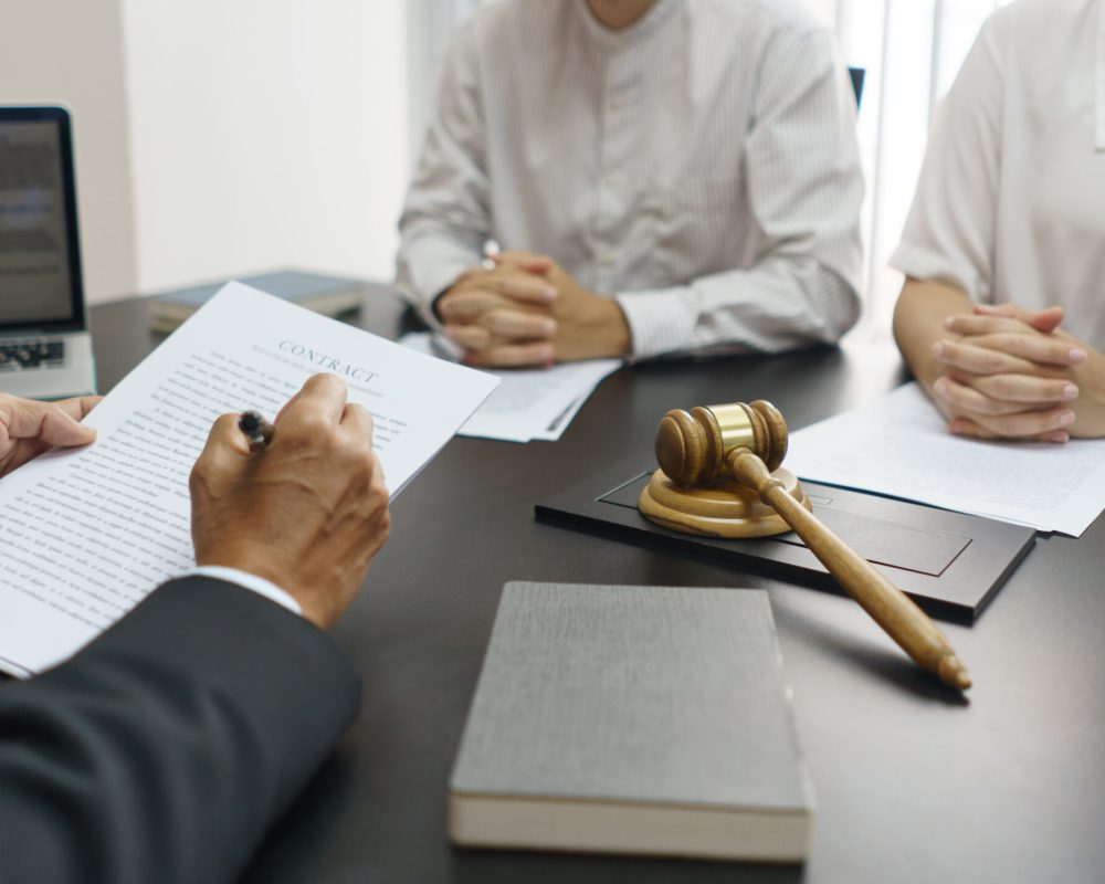 Concept of lawyer counseling, Senior lawyer explains the divorce agreement and contract to couple.